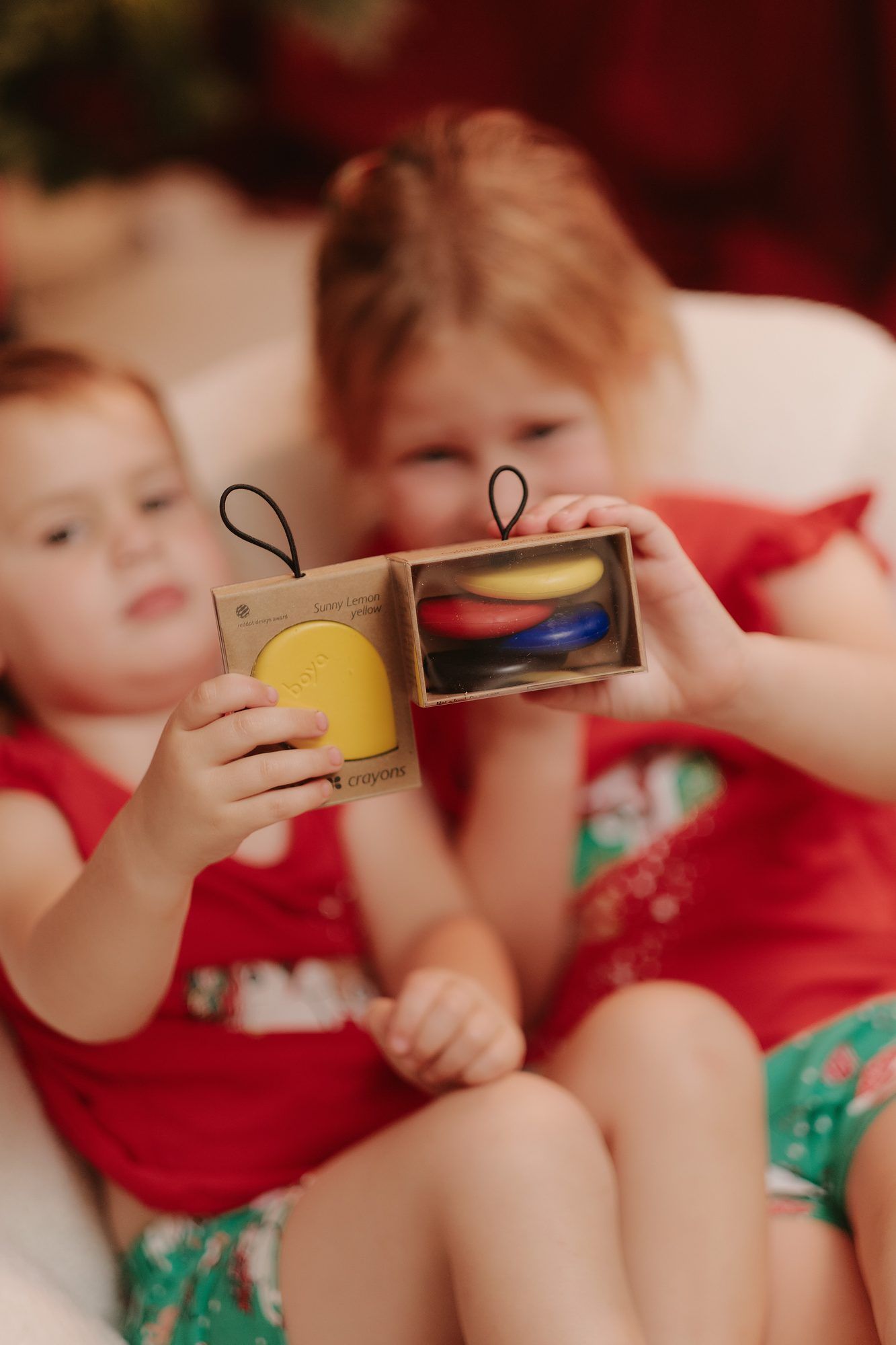 Boya: Two children holding up a Boya ornament together