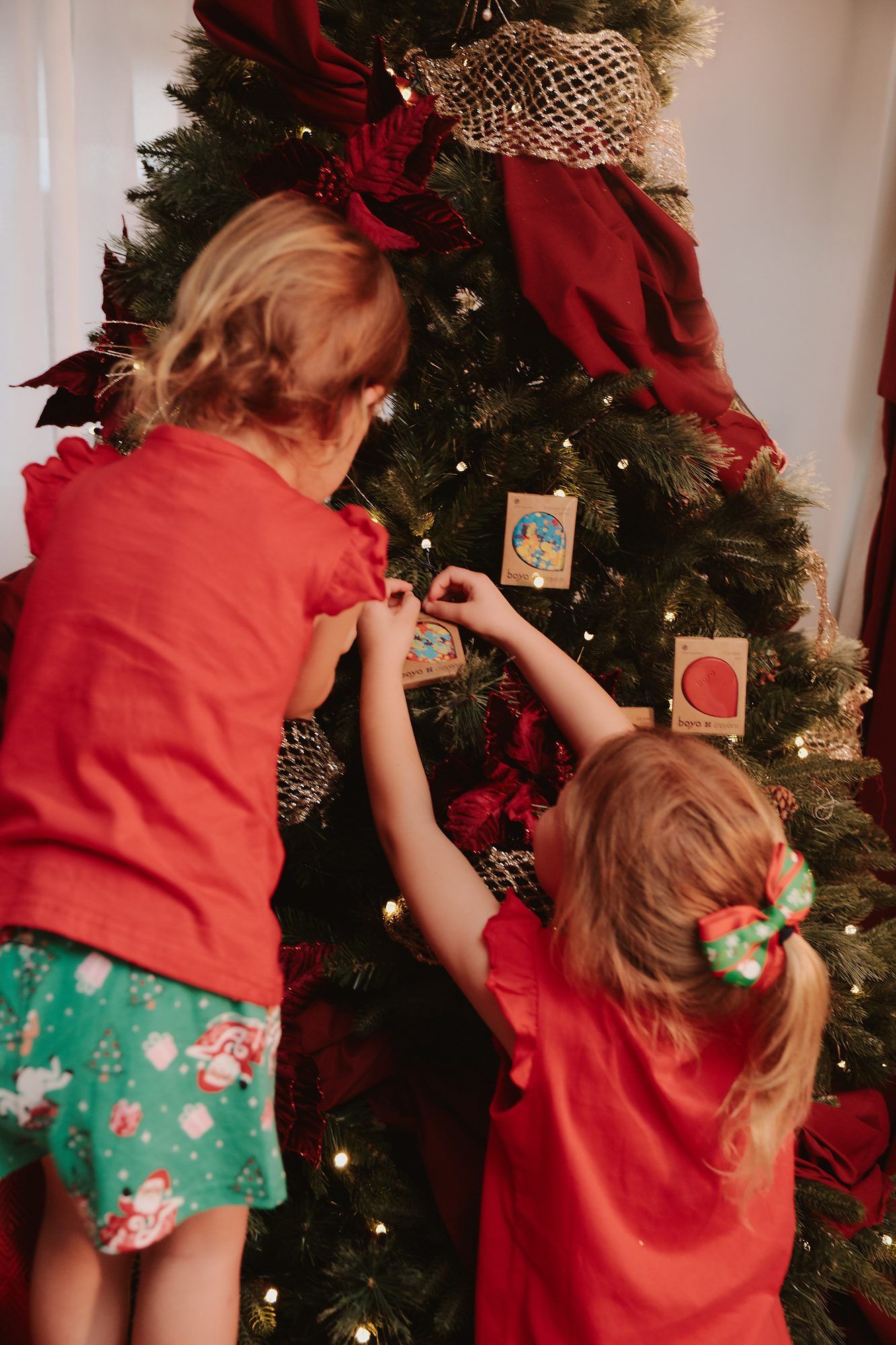 Boya: Children hanging decorations on a Christmas tree