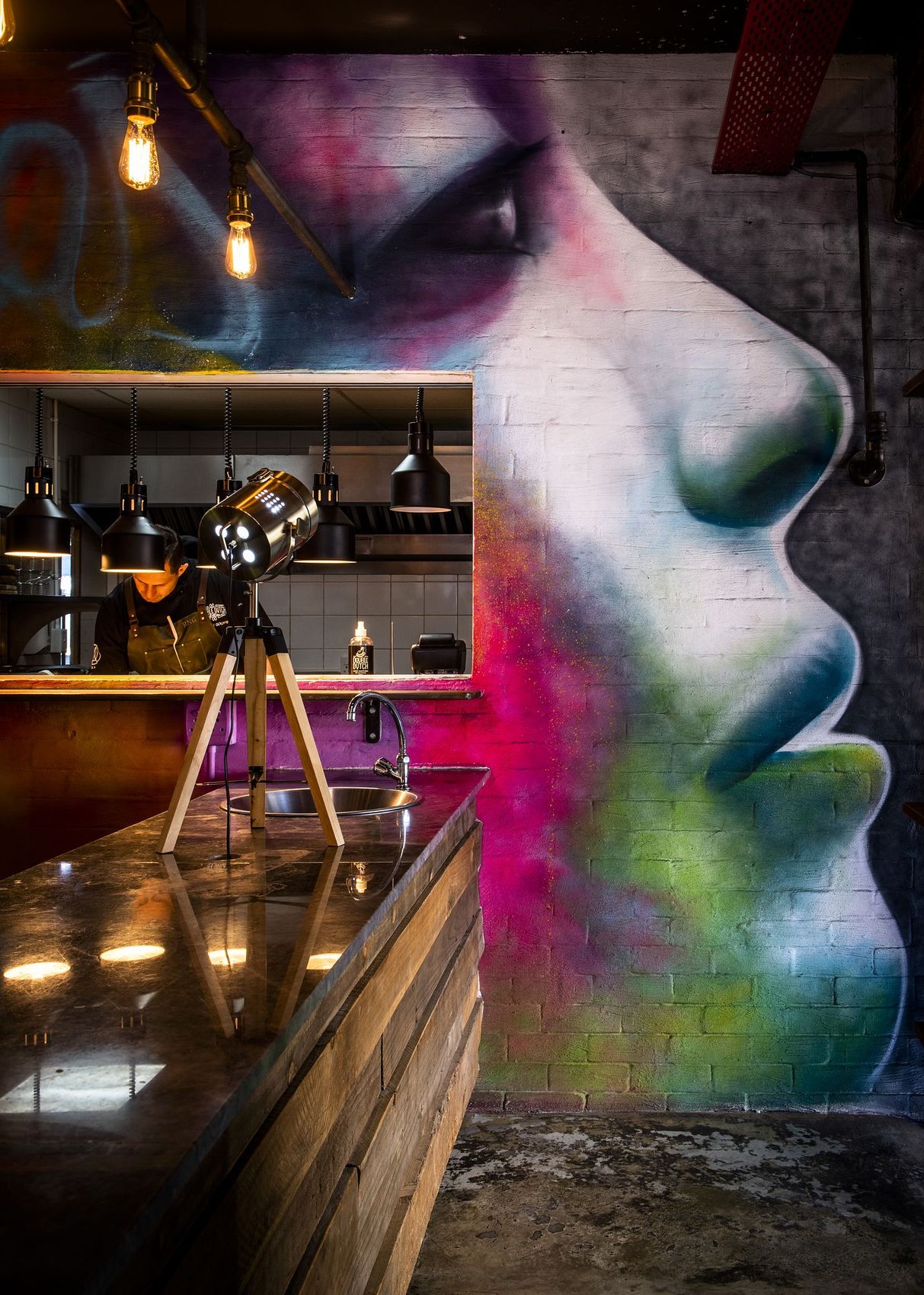 Double Dutch: Bright mural of a face behind the bar