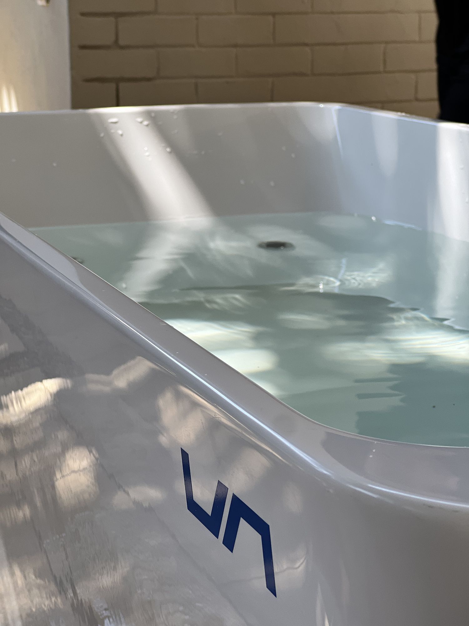 Dunk: Dunk logo on the side of a filled ice bath
