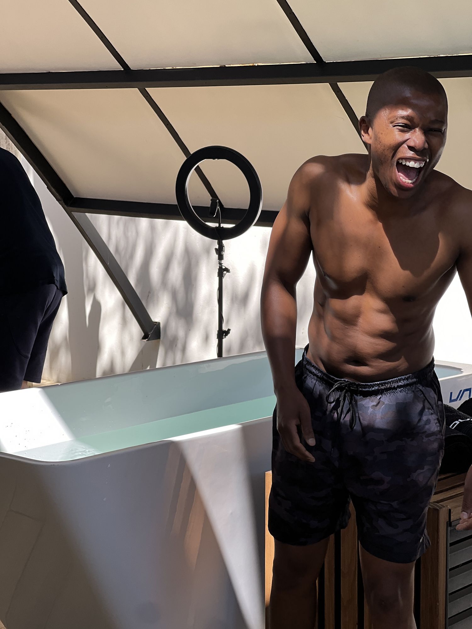 Dunk: Man laughing beside an ice bath during the shoot
