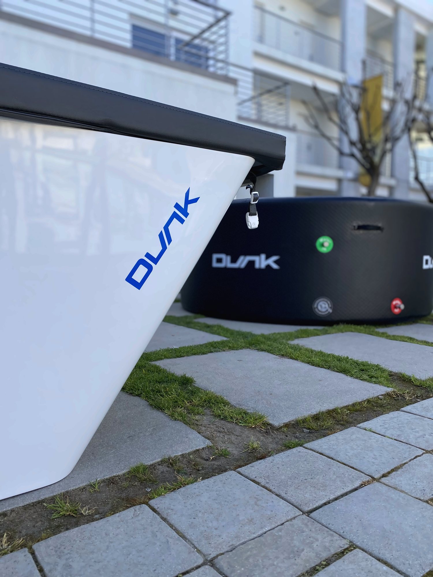 Dunk: Close-up of the Dunk wordmark on a white tub, with a black Dunk behind
