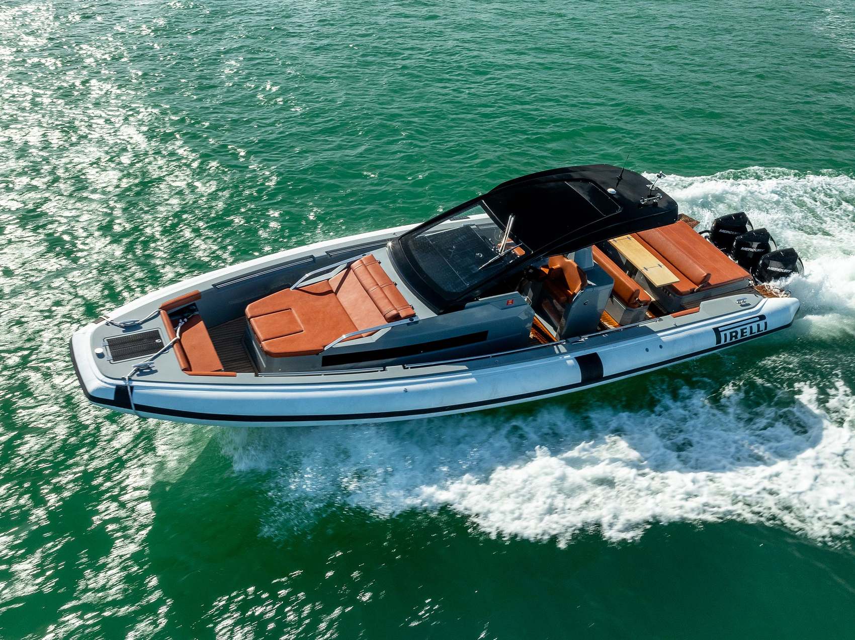 Maverick: Tender with orange cushions speeding across the water