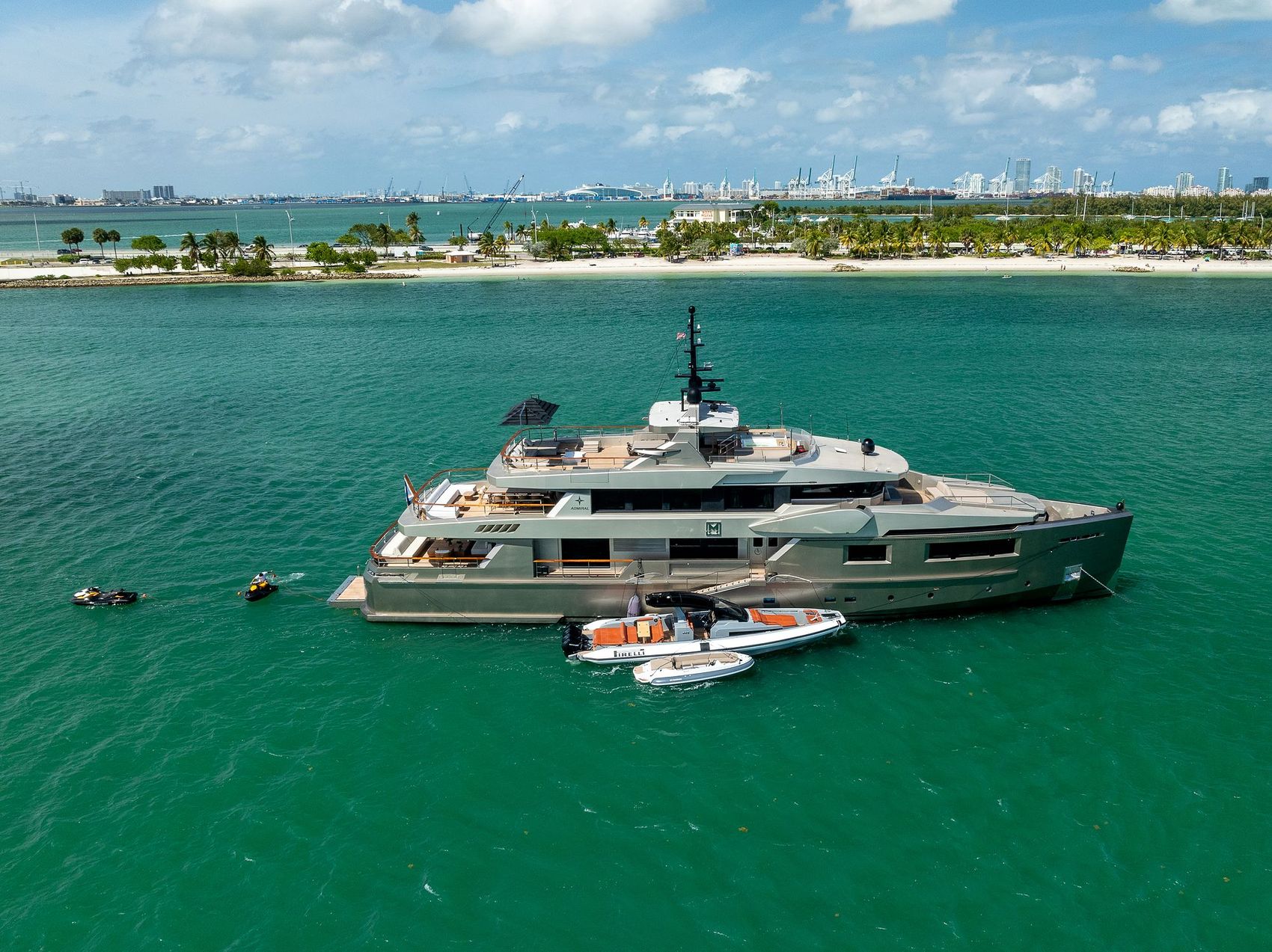 Maverick: Maverick at anchor off a palm-lined shore with her tenders