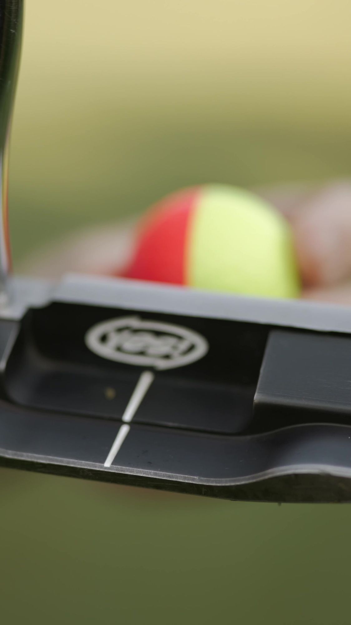 My Golf Pro: Close-up of a putter face behind a red and yellow ball