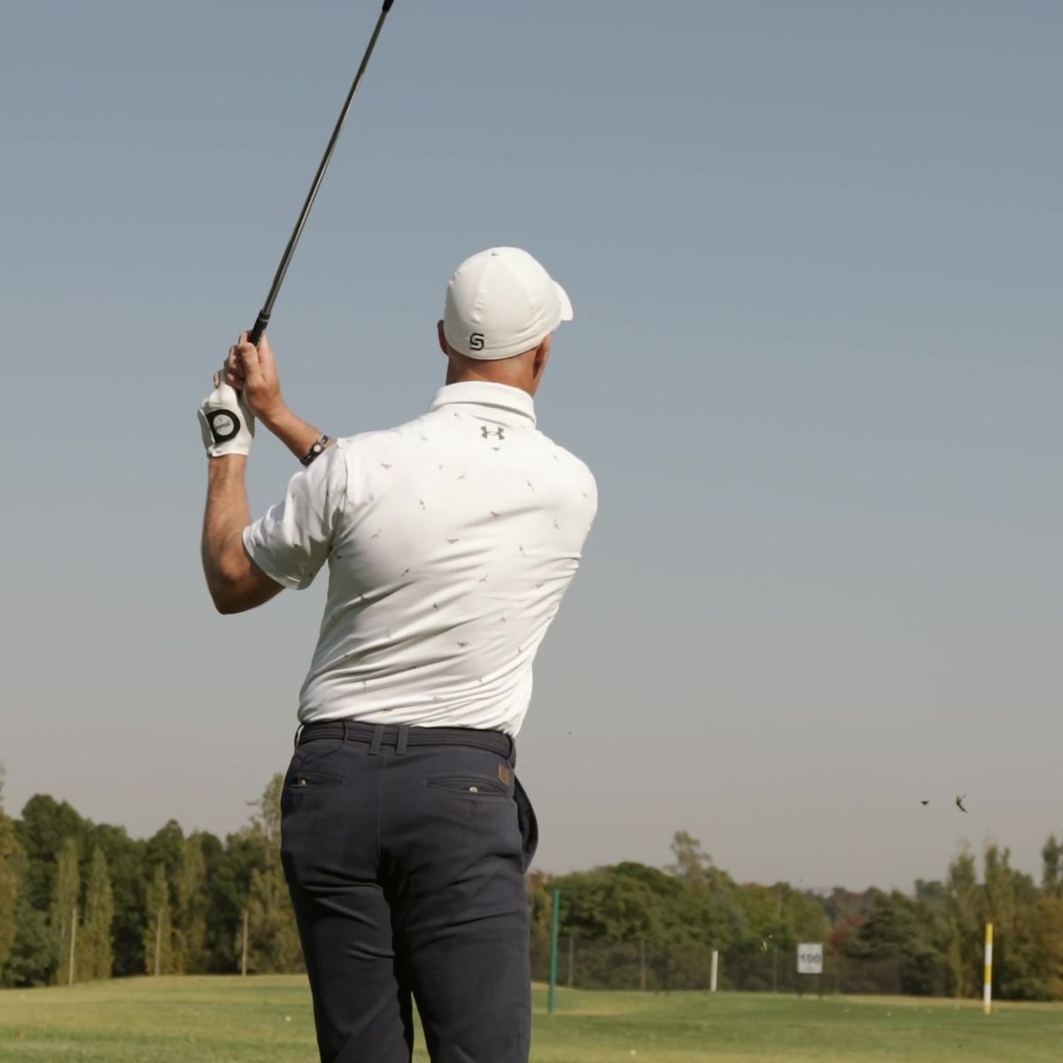 My Golf Pro coaching series: golf pro mid-swing against a clear sky