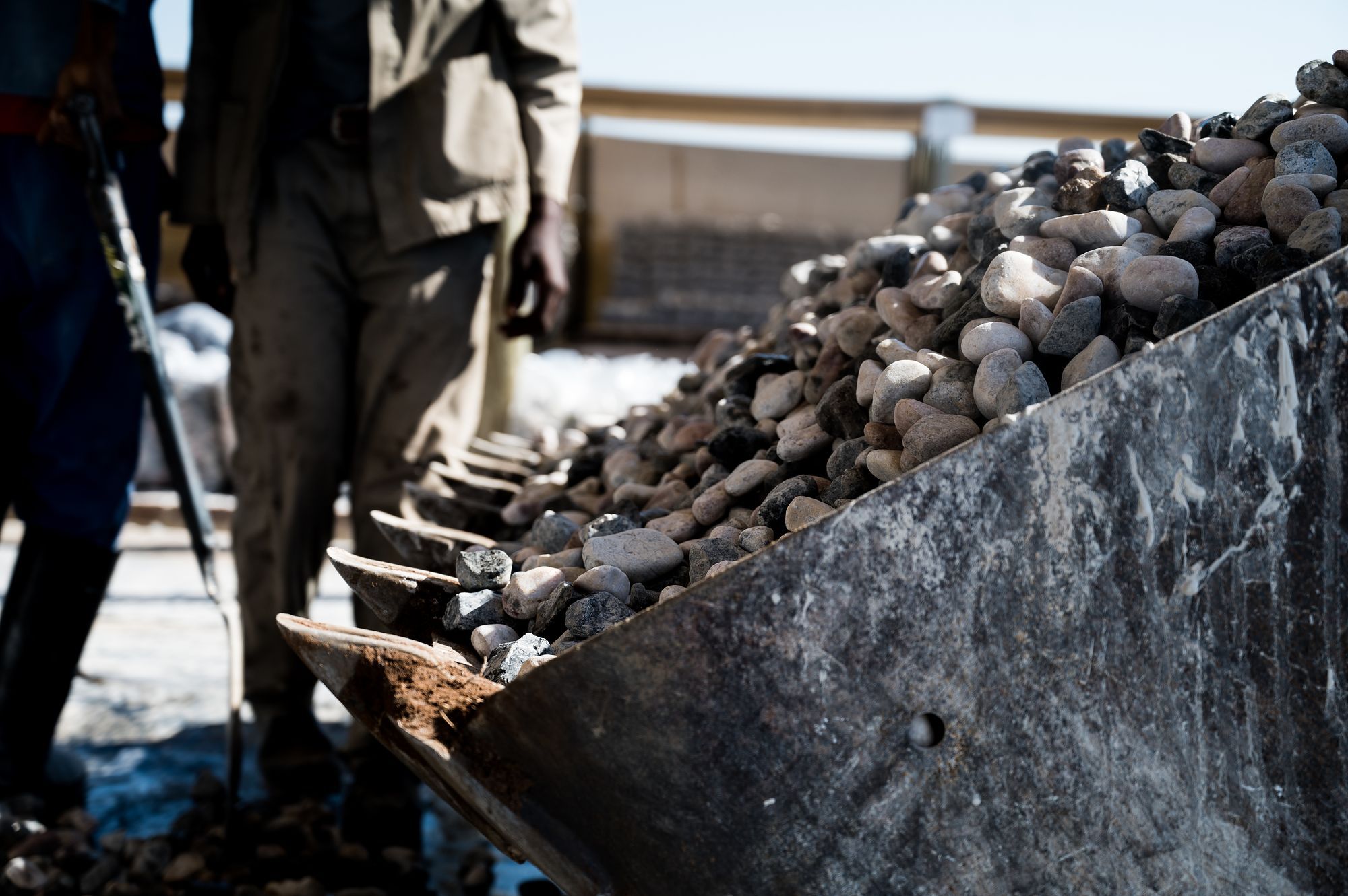 Pebble Africa: Shovel loading pebbles into a wheelbarrow