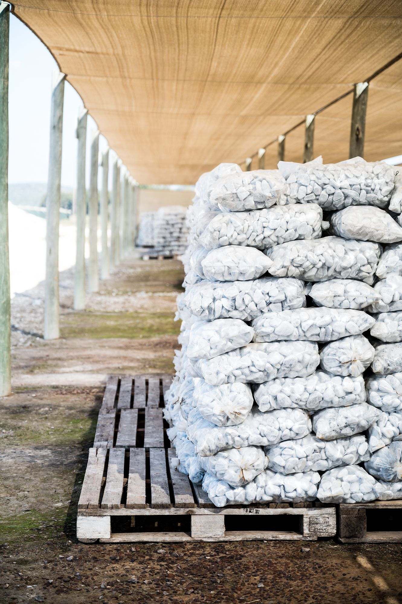 Pebble Africa: Bags of white pebbles stacked on a pallet