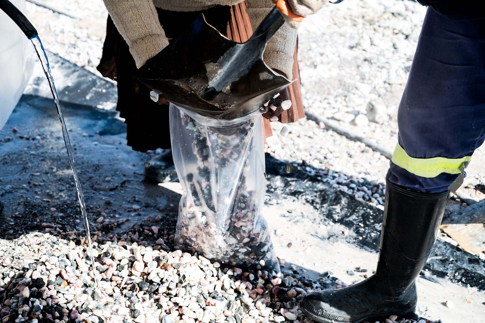 Pebble Africa: Pebbles being poured into a bag