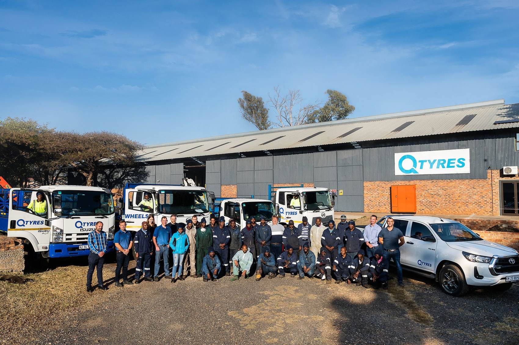 Q Tyres: The Q Tyres team lined up with trucks and bakkies outside the plant