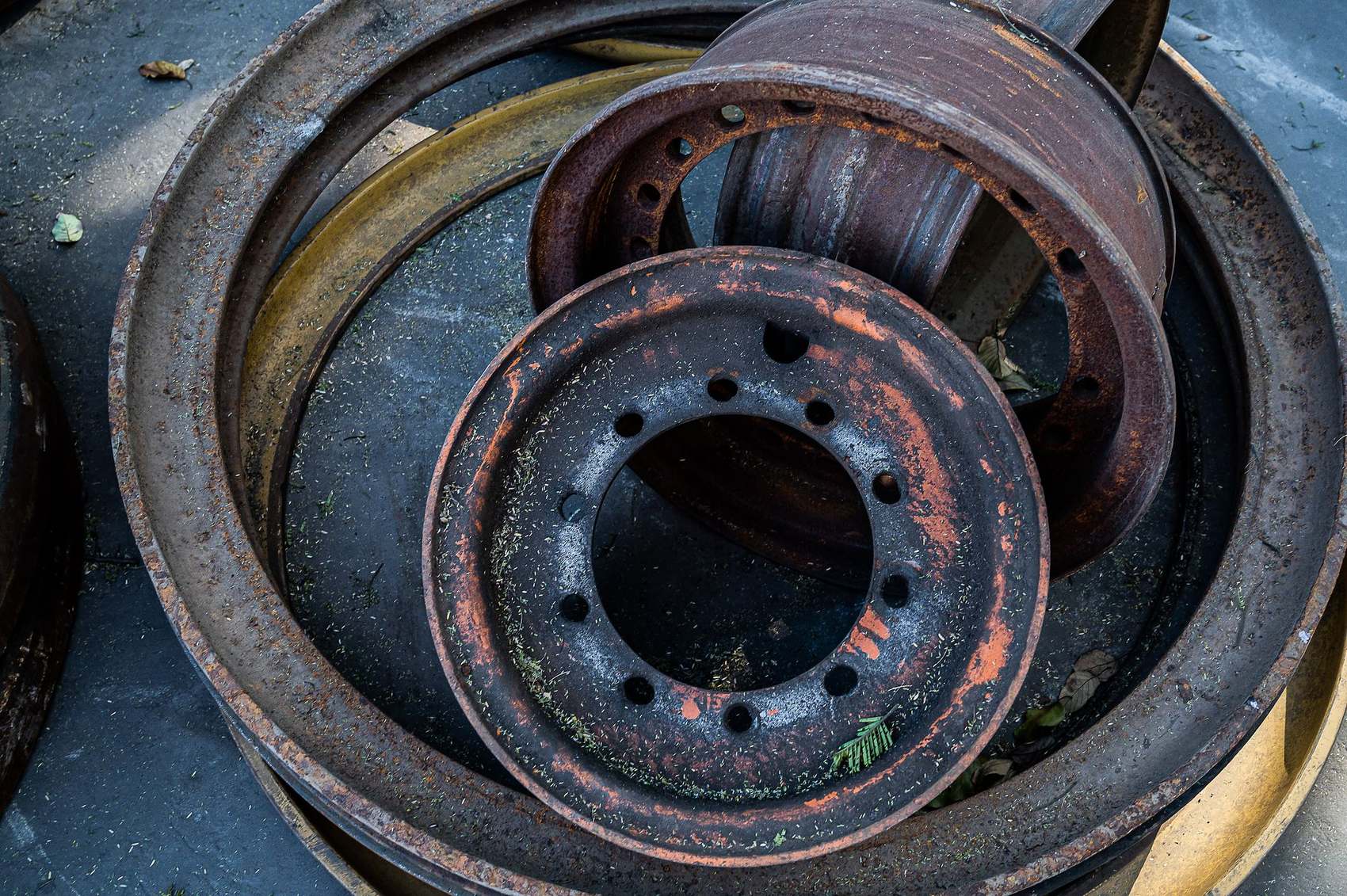 Q Tyres: Close-up of stacked, weathered steel wheel rims