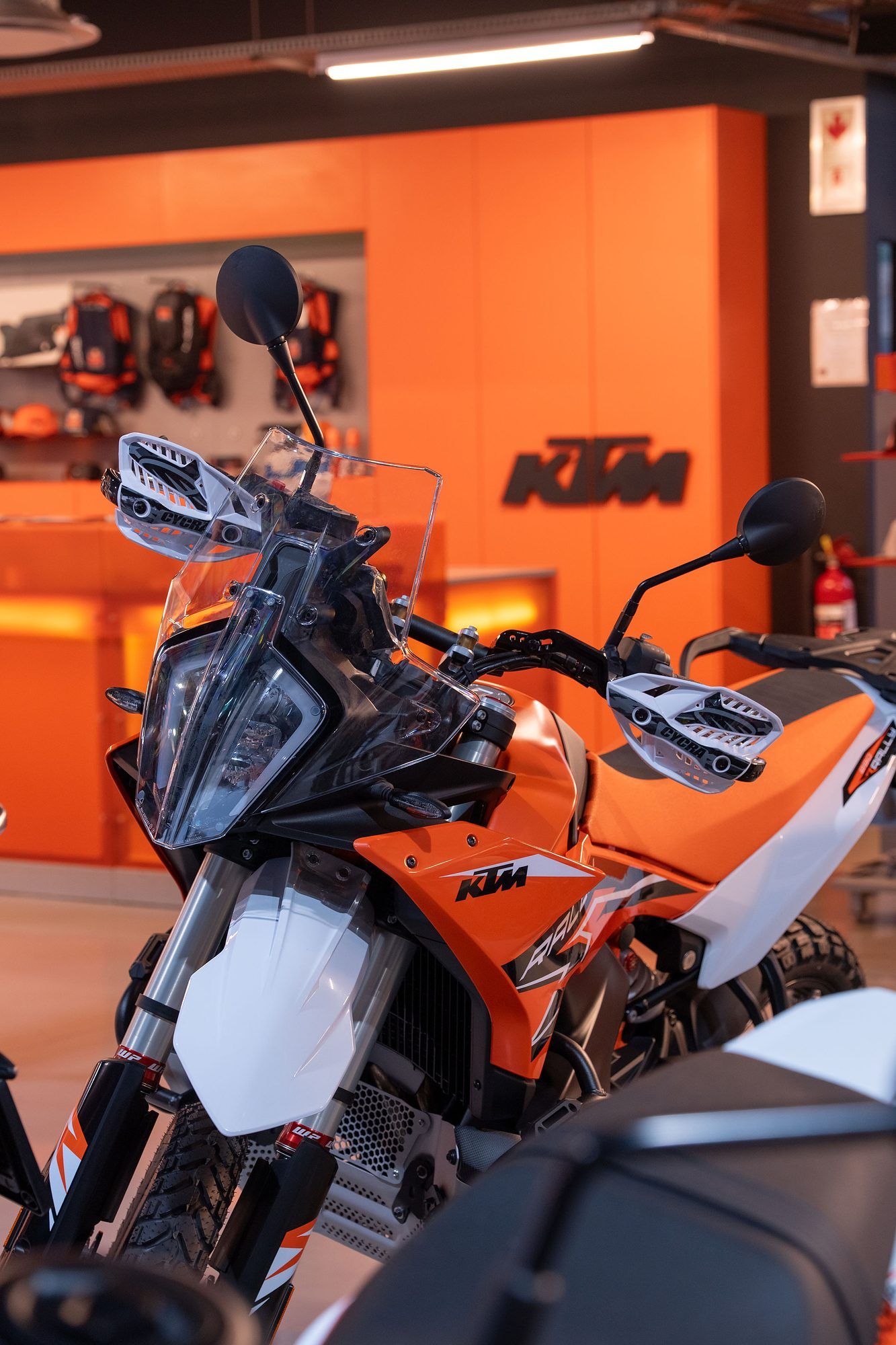 Raceworx: Orange KTM adventure bike in the showroom
